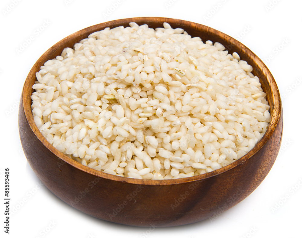 Rice in a wood bowl on a white background Rice in a wood bowl on a white background