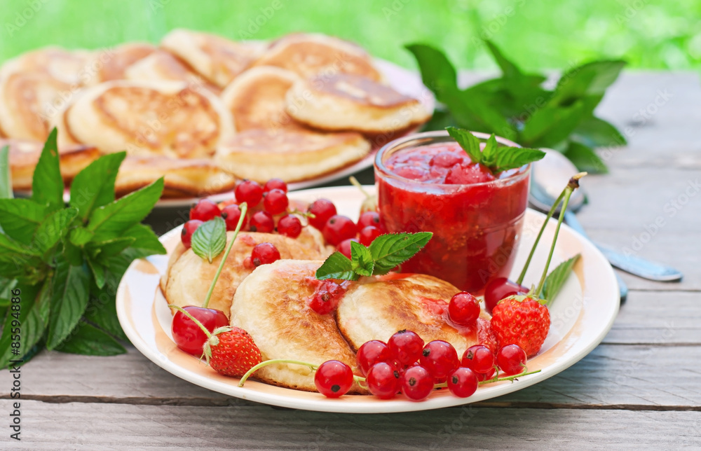 Pancakes with berries on a wooden background Pancakes with berries on a wooden background