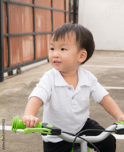 Asian little boy on a bike