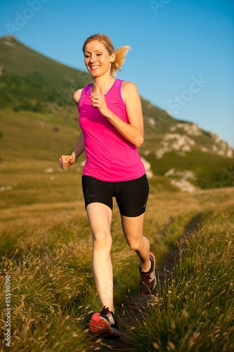 beautiful young woman runns cross country on a mountian path at © Samo Trebizan