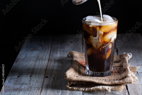 Fototapeta Iced coffee in a tall glass