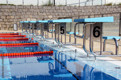 View of a row of diving boards in a Olympic pool.