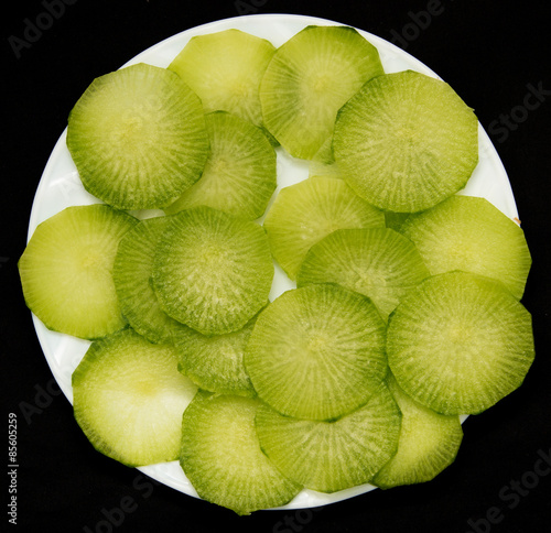 green radish on a black background photo