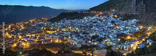 Evening panorama of Chefchaouen with buildings painted in blue color from the hill of Jemaa Bouzafar Mosque, Morocco