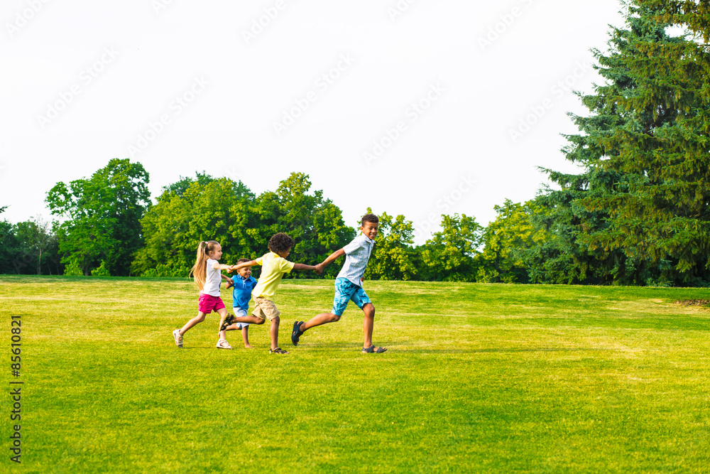Four children are playing on the glade. Four children are playing on the glade.