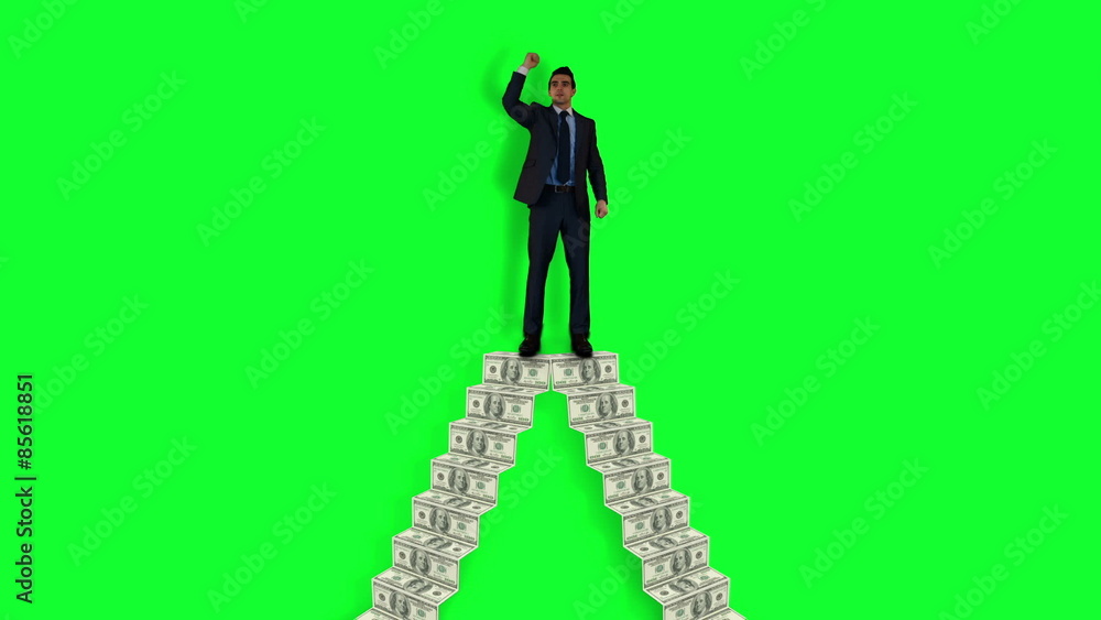 Businessman cheering on money pile Businessman cheering on money pile