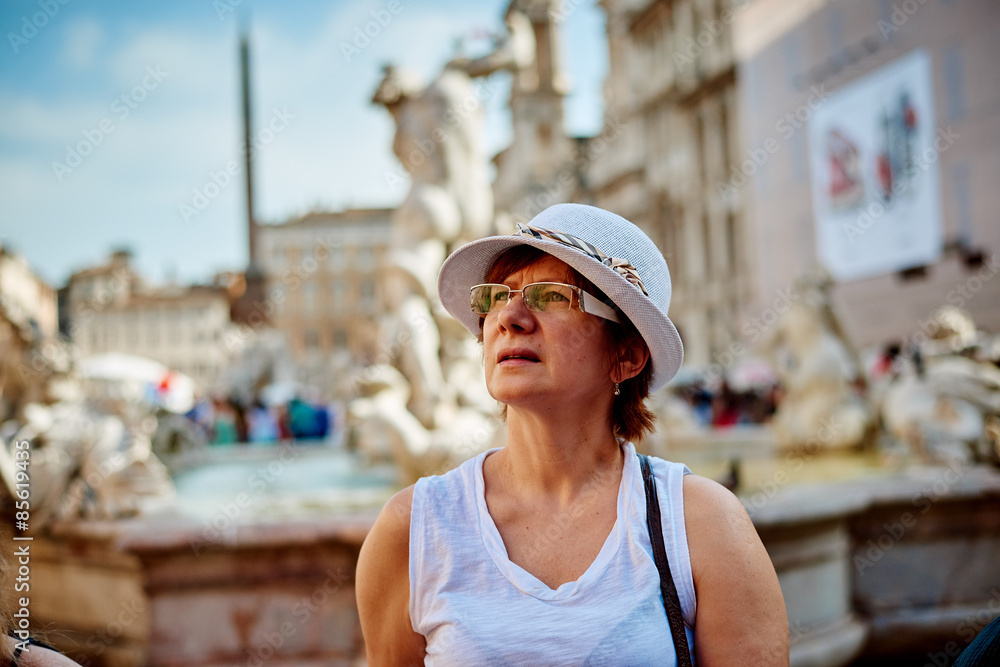 Woman in hat in Rome on Piazza Navona. Tourist on vacation travel smiling happy walking joyful in Italy, Europe.