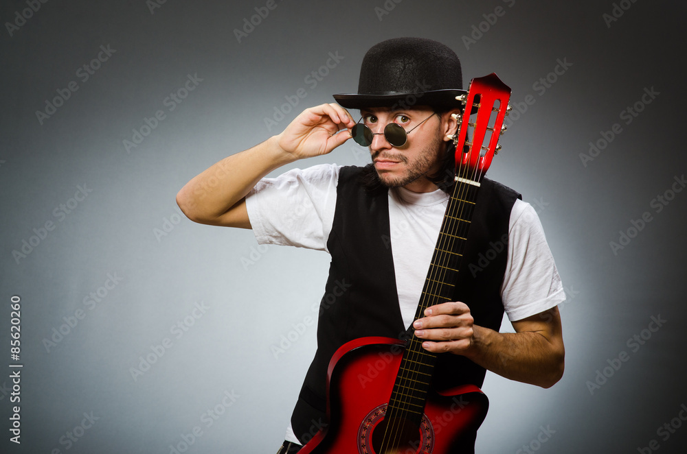 Man wearing sunglasses and playing guitar