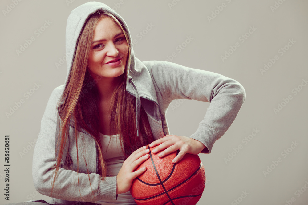 Fototapeta premium Sporty teen girl in hood holding basketball.