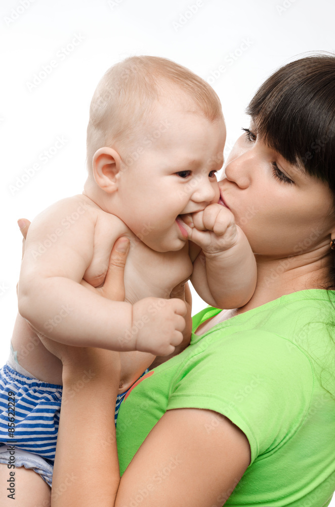 young mother kissing her little children young mother kissing her little children