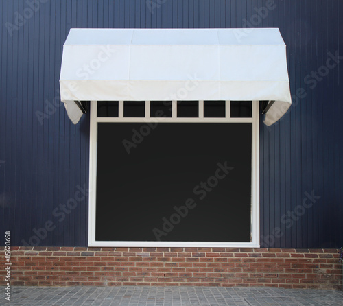 Shopfront vintage store front with canvas awnings and blank disp photo