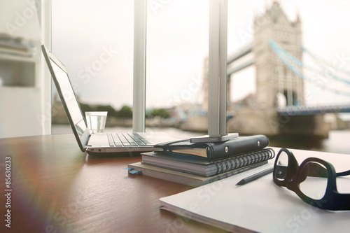 Photography laptop computer is on wooden desk as workplace concept with over