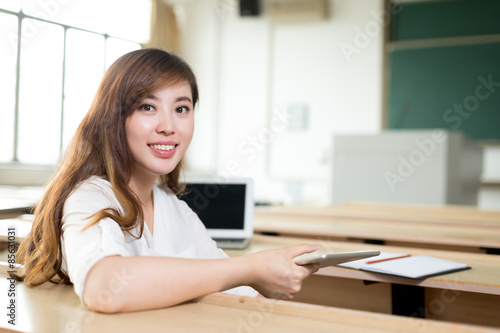 Asian beautiful woman using tablet in classroom