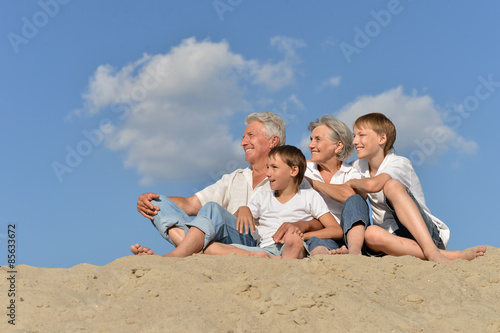 Boys with grandparents on the sand