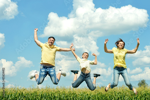Happy family jumping on sky background