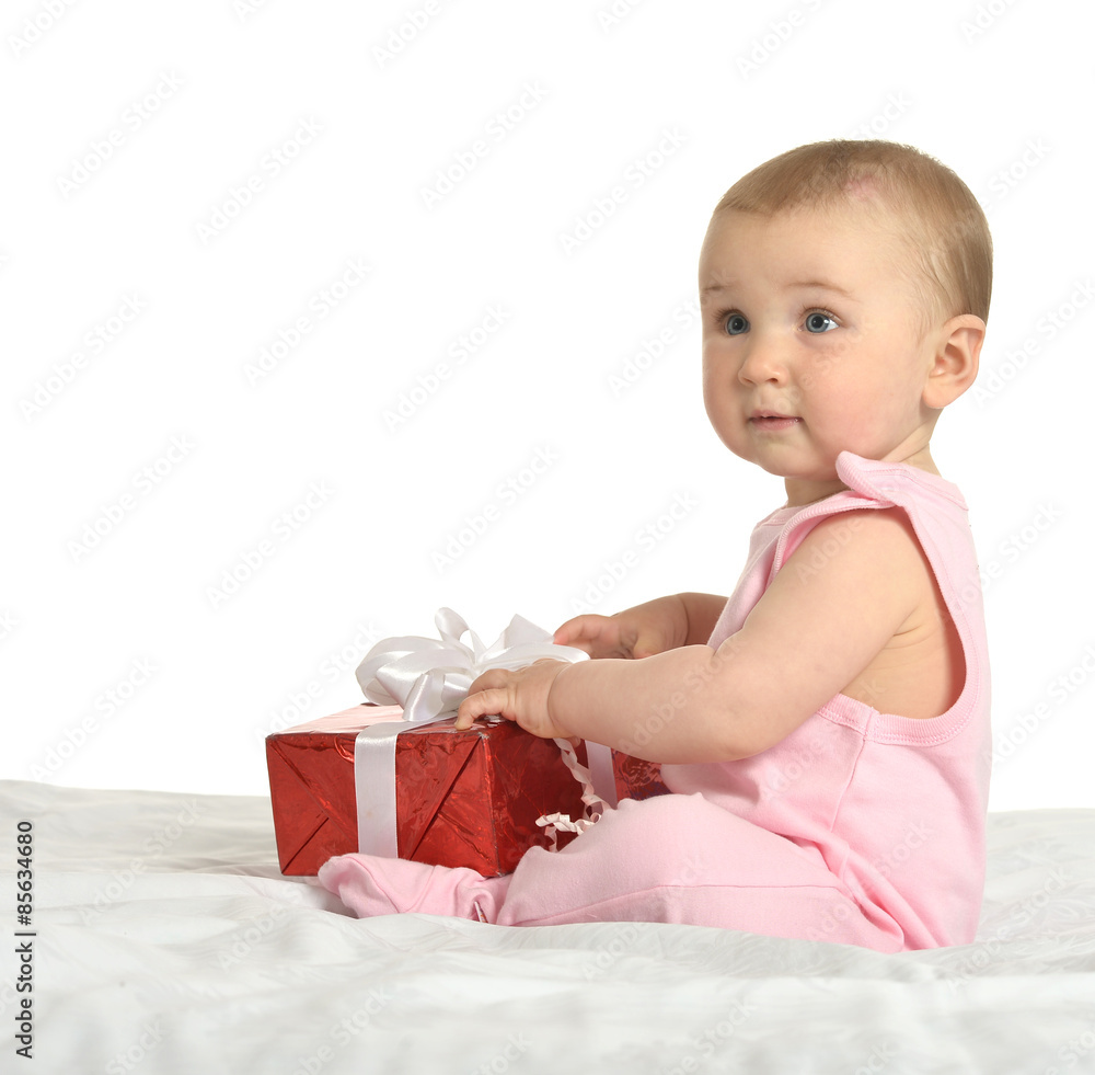 Baby girl sitting with gift Baby girl sitting with gift