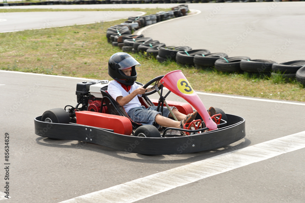 Fototapeta premium Teenage boy sitting in go-kart