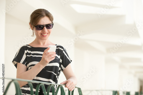 Young happy woman using app mobile on phone