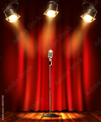 Stage with red curtians, microphone and spotlight.