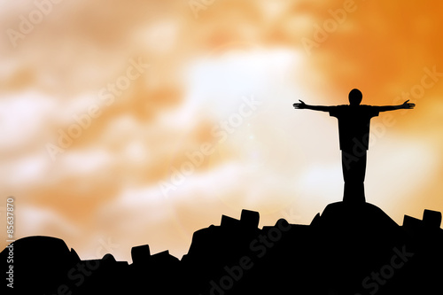 sillouette man with faith praying under god light