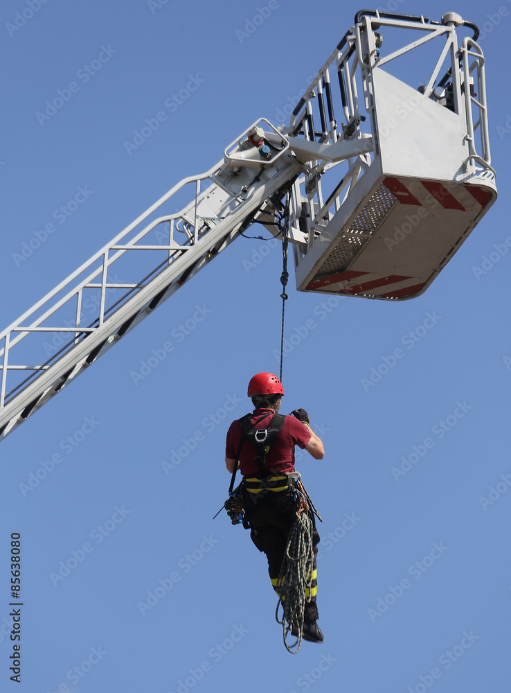 fireman  hung the rope climbing during fire drill