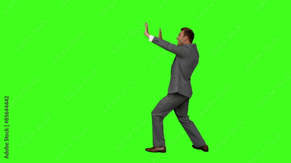 Businessman standing and pushing Businessman standing and pushing