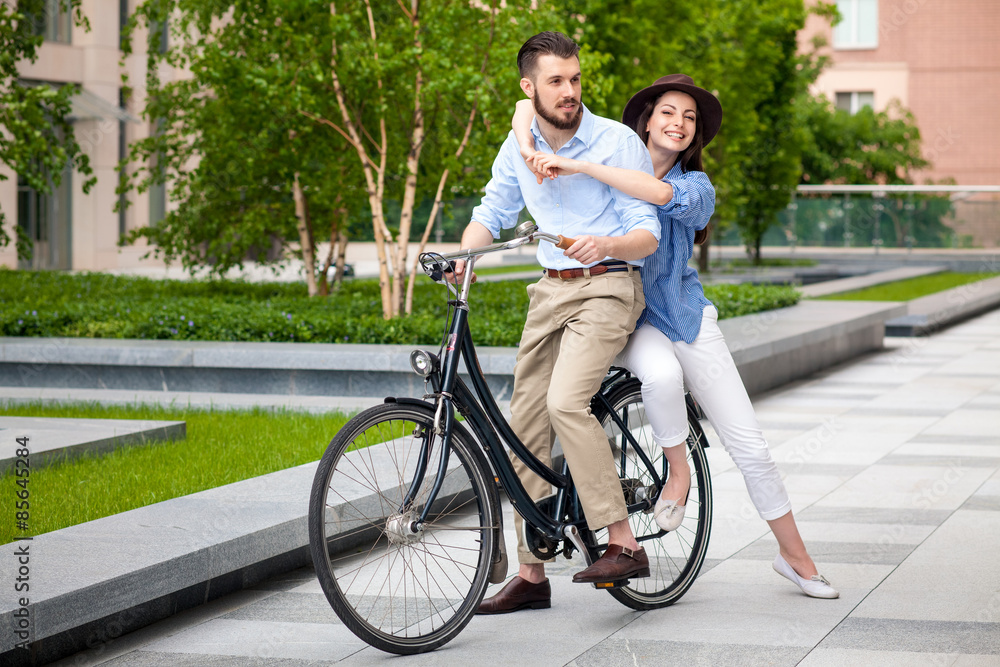 Young couple sitting on a bicycle Young couple sitting on a bicycle