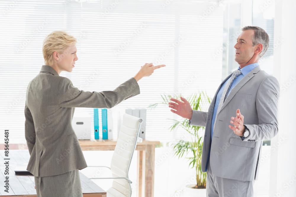 Businesswoman giving out to her boss Businesswoman giving out to her boss