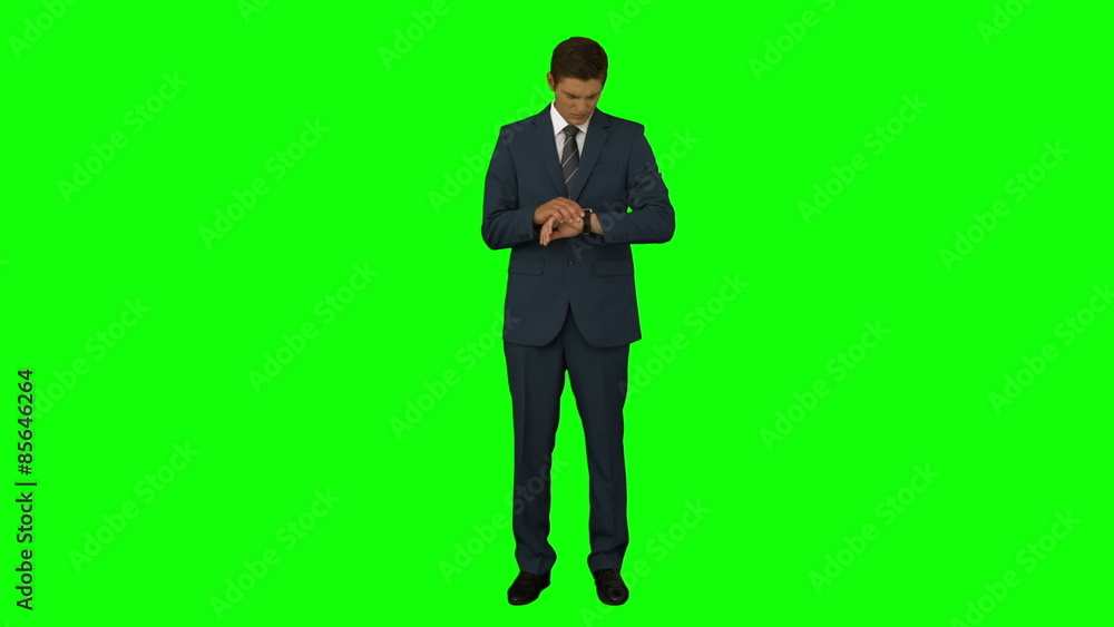 Businessman standing and checking time Businessman standing and checking time