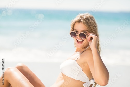 Happy pretty blonde looking at camera with sunglasses 