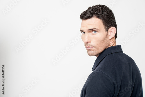 Calm man looking back over his shoulder