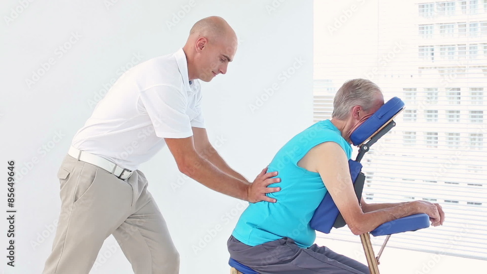 Doctor massaging his patients back Doctor massaging his patients back