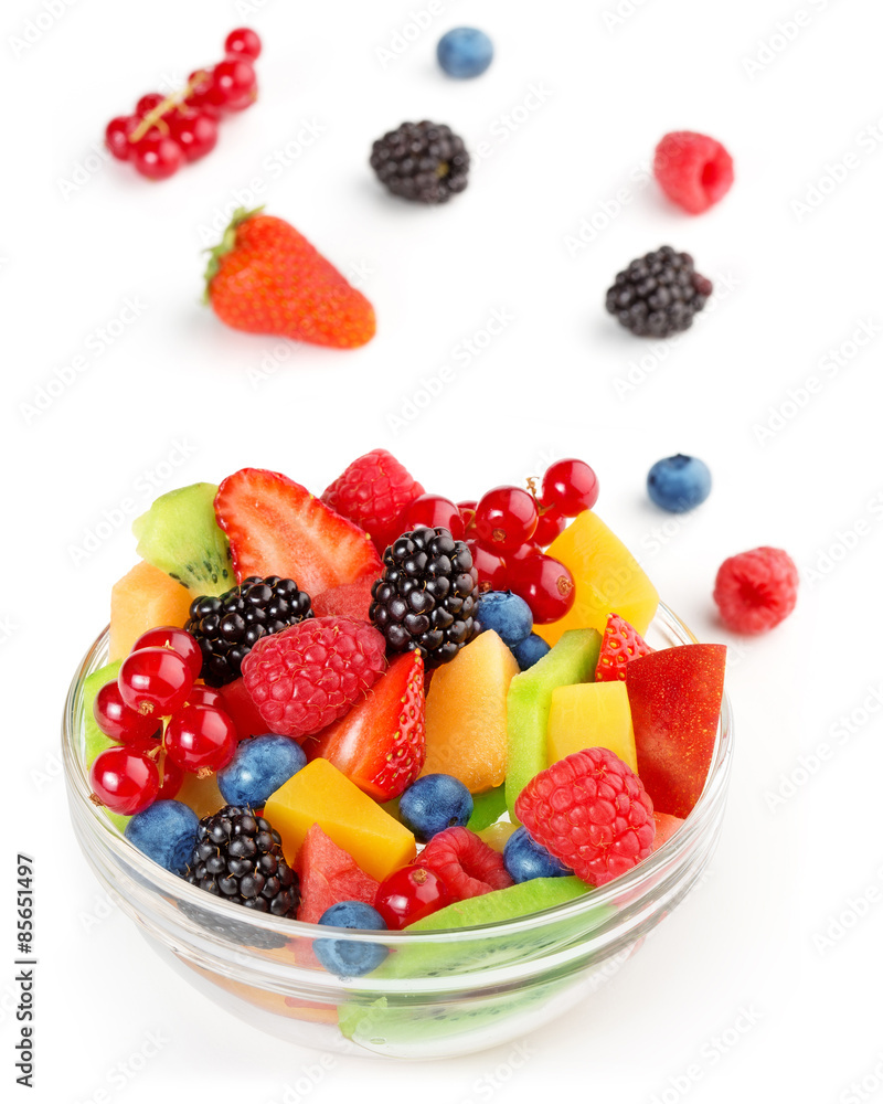portion of vibrant fruit salad and scattered fruits on white background portion of vibrant fruit salad and scattered fruits on white background