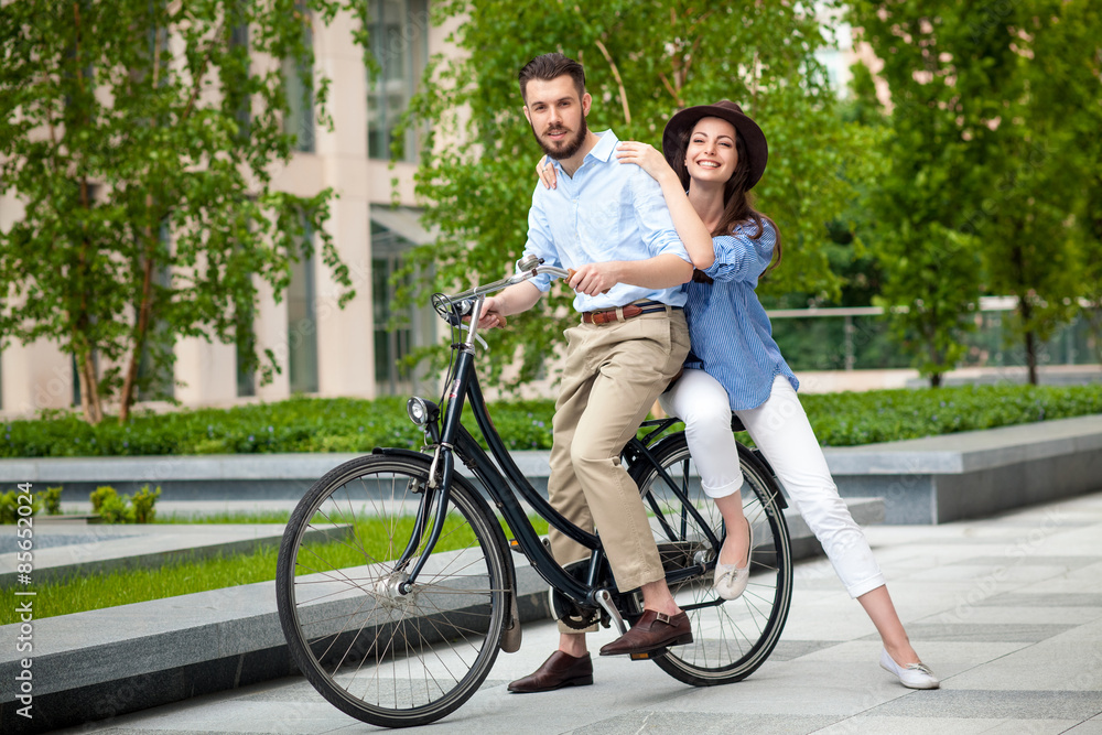 Young couple sitting on a bicycle Young couple sitting on a bicycle