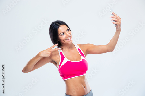 Happy fitness woman making selfie photo