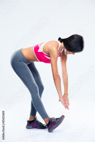 Full length portrait of a sporty woman stretching