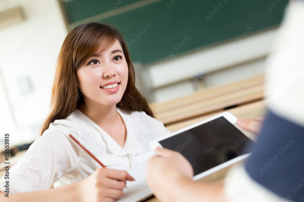Two asian student discuss content on tablet when study in classr Two asian student discuss content on tablet when study in classr