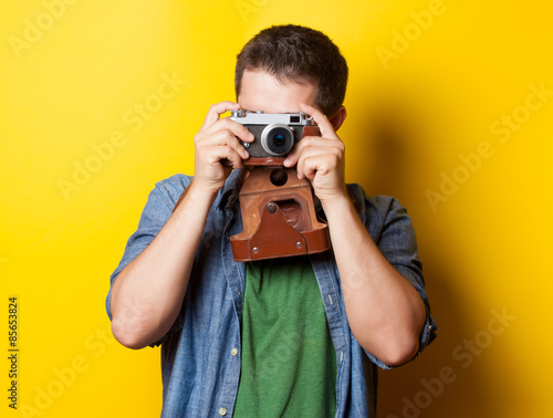 guy in shirt with vintage camera