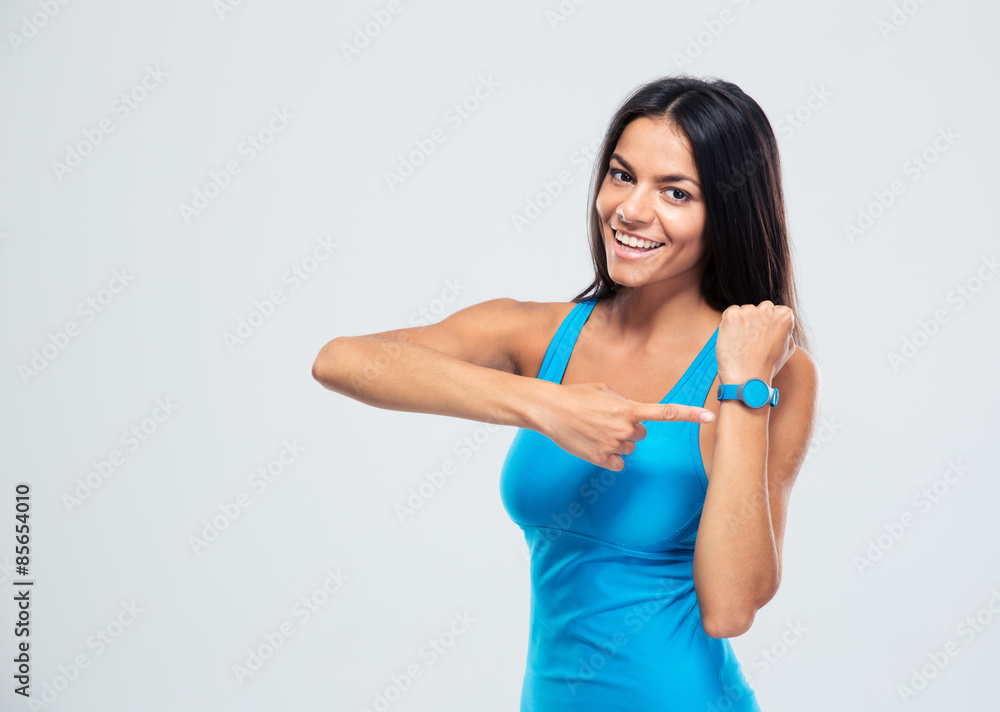 Happy fitness woman pointing on fitness tracker Happy fitness woman pointing on fitness tracker