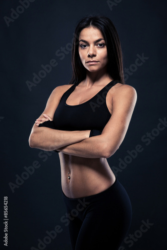 Fitness woman standing with arms folded