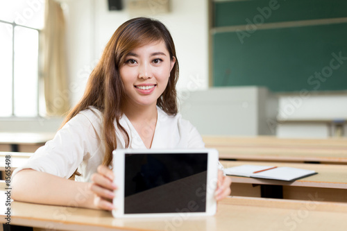 Asian beautiful woman using tablet in classroom