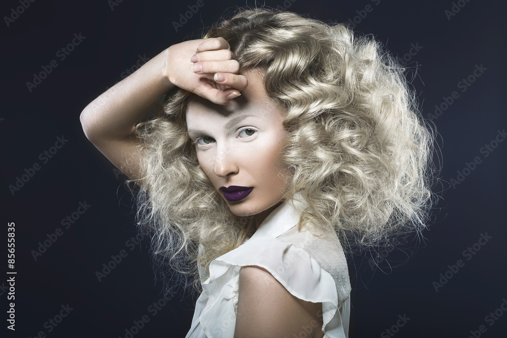 Art photo of beautiful girl with violet lips and pale eyes. Picture taken in the studio on a blue background. Art photo of beautiful girl with violet lips and pale eyes. Picture taken in the studio on a blue background.