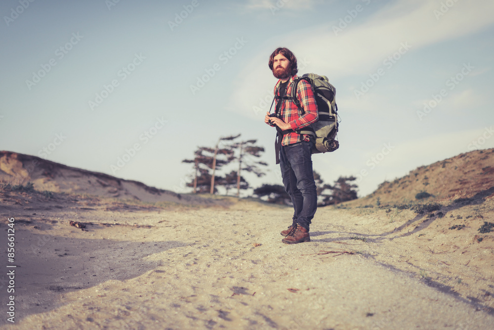 Photographer standing on a sandy trail