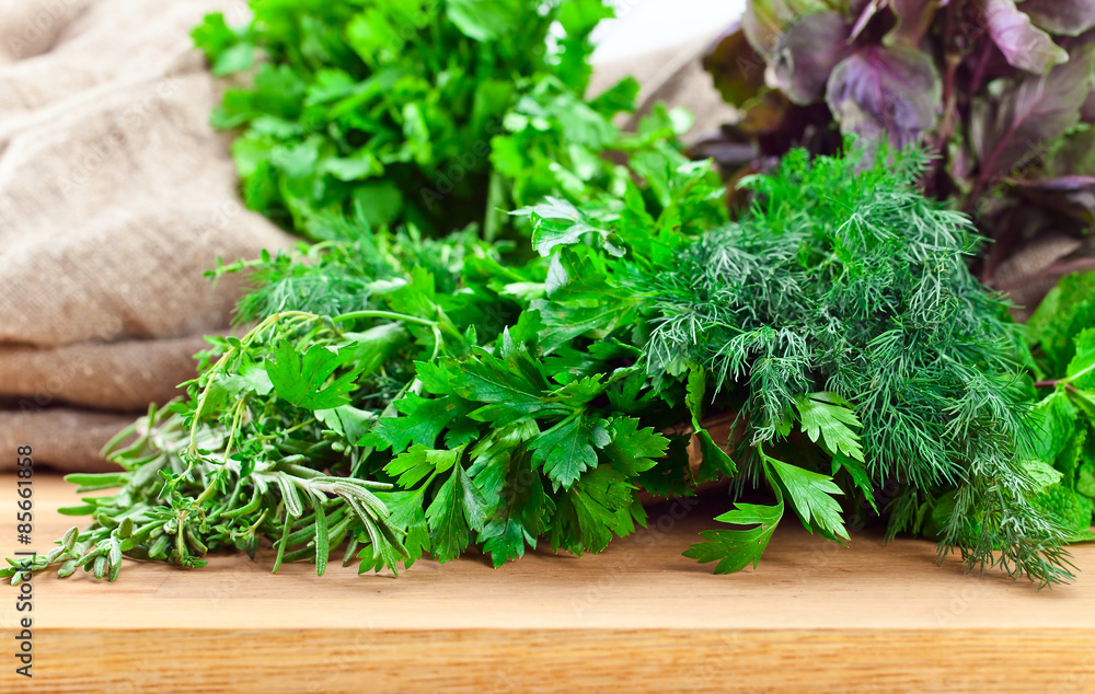 Kitchen herbs on wooden table Kitchen herbs on wooden table