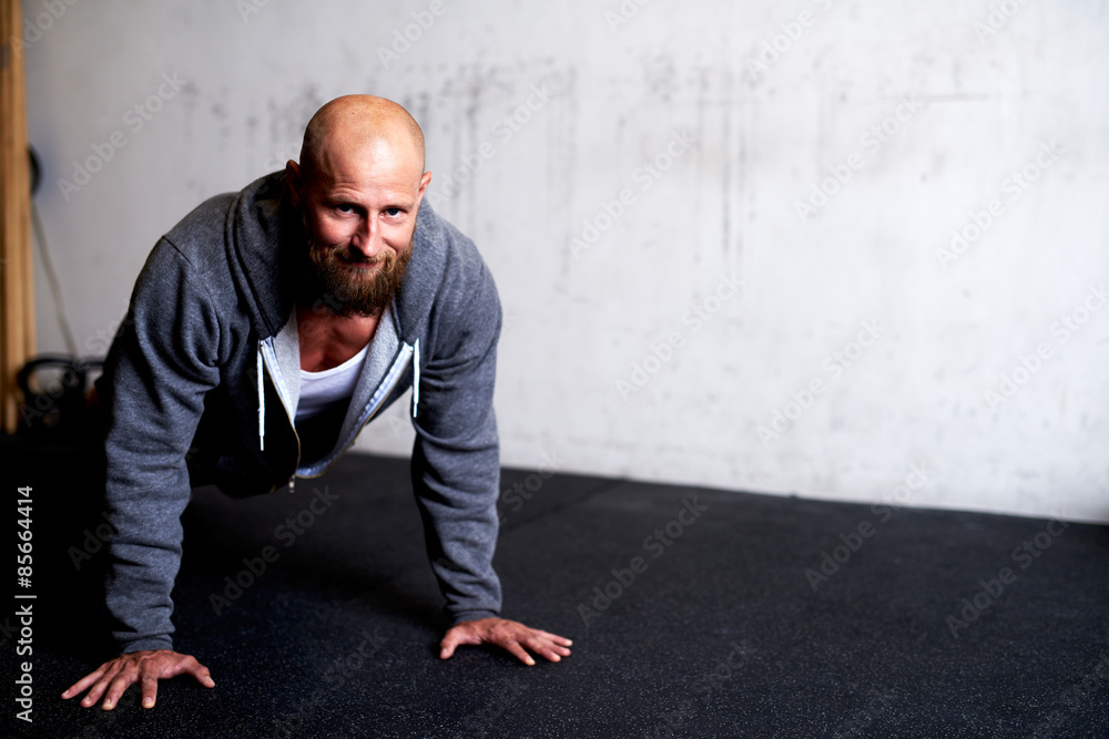 Muscular man smiling at camera while doing pushup Muscular man smiling at camera while doing pushup