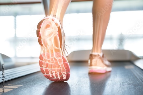 Highlighted foot of woman on treadmill photo