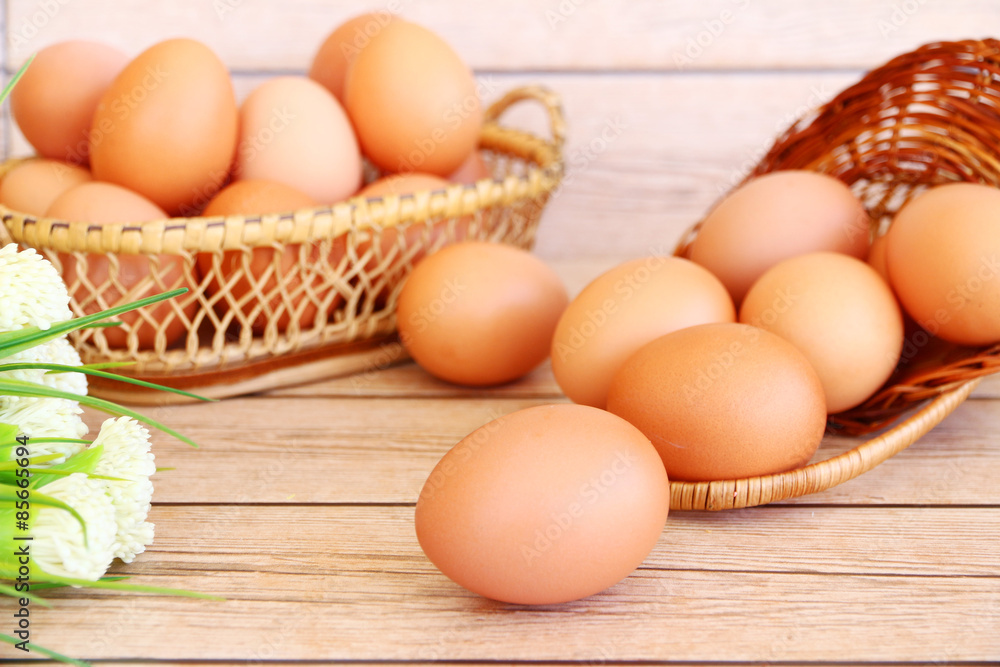 Eggs in the basket on wooden background Eggs in the basket on wooden background