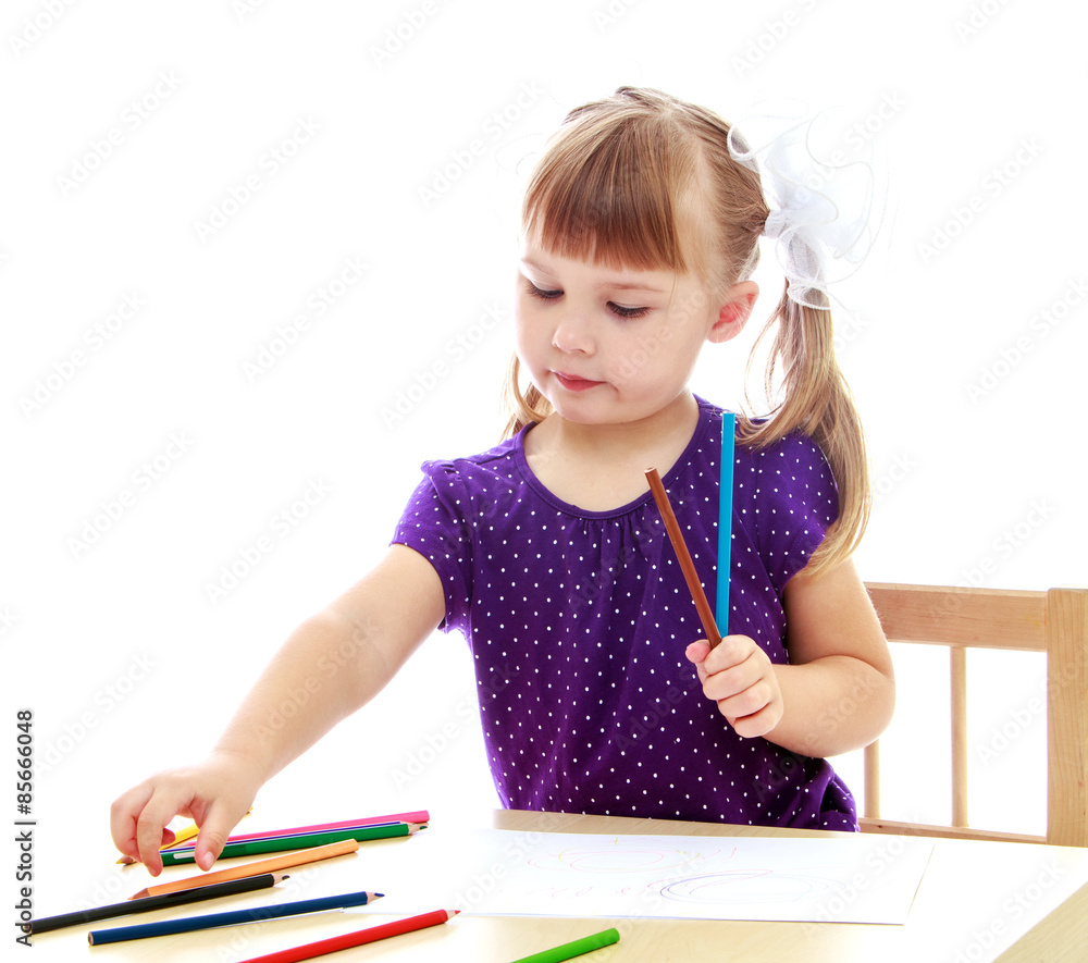 Cute little girl drawing with markers at the table Cute little girl drawing with markers at the table