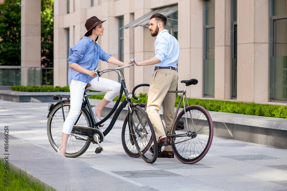 Romantic date of young couple on bicycles Romantic date of young couple on bicycles