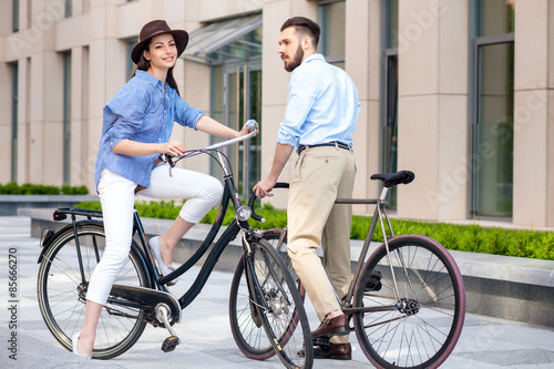 Romantic date of young couple on bicycles